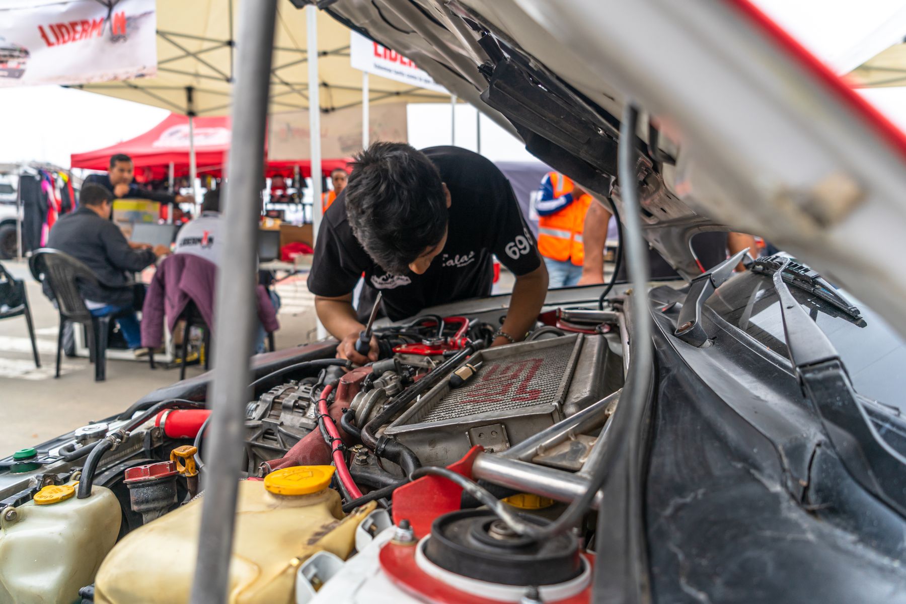 A mechanic inspecting a car engine during hands-on automotive service